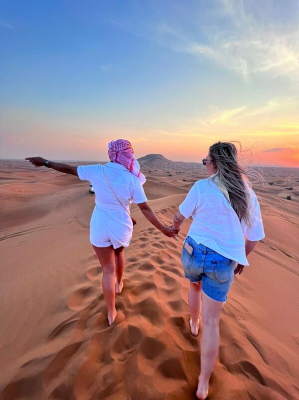 Couple on high sand dunes in dubai safari