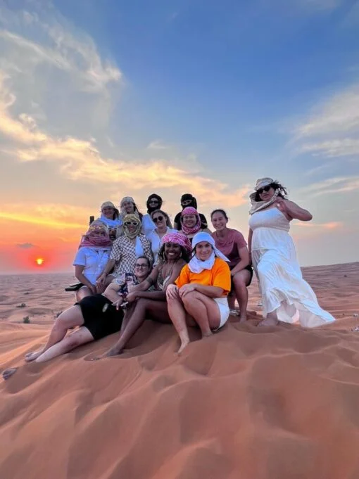 group photo of tourists on a high dune desert - Desert Safari Dubai