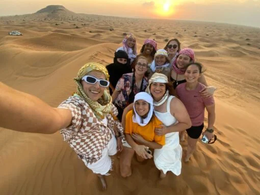 group photo on the sunset point tourists standing taking a selfie - Desert Safari Dubai