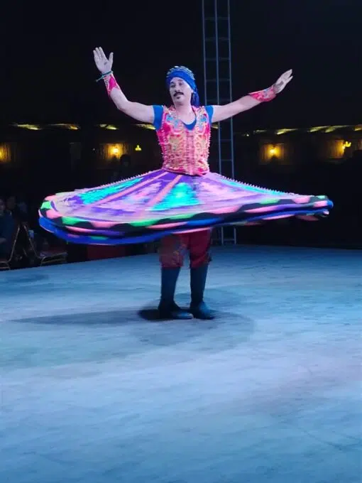 sufi tanoura show at desert safari tour on the stage