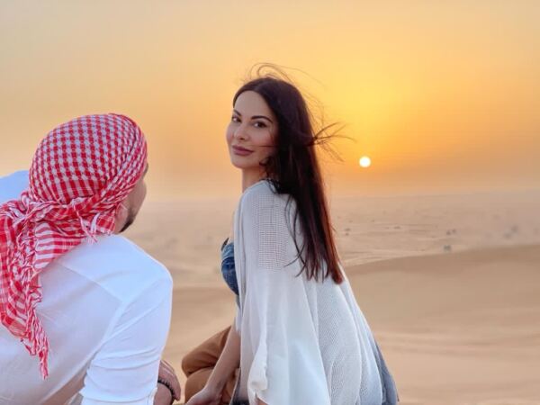 couple at sunset point in desert safari